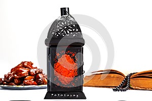 The Muslim feast of the holy month of Ramadan Kareem. Beautiful background with a shining lantern Fanus and dried dates on white w