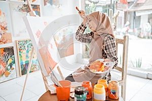 muslim female artist while working in her project at studio