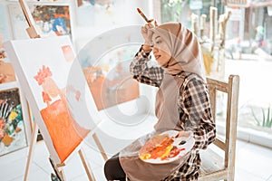 muslim female artist while working in her project at studio