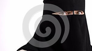 Muslim female in black niqab. Closeup