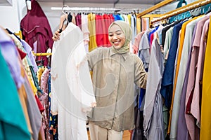 muslim female confuse of choosing between two clothes