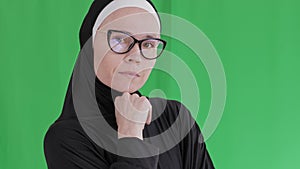 Muslim female in eyeglasses and hijab.