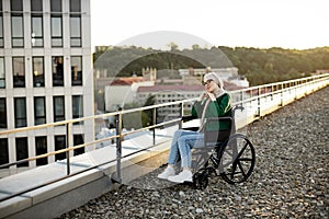 Muslim female with mobility issues daydreaming on terrace