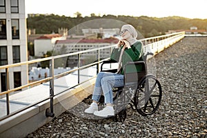 Muslim female with mobility issues daydreaming on terrace