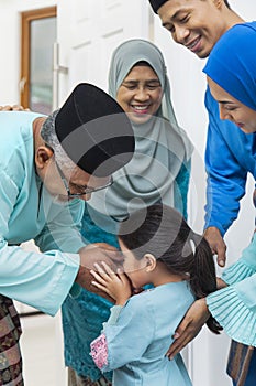 Muslim girl greeting her grandparent
