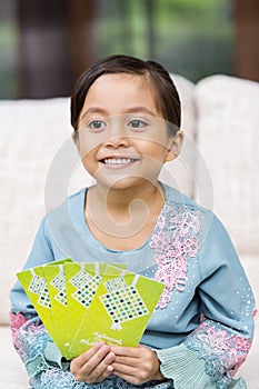 Muslim girl holding green envelopes