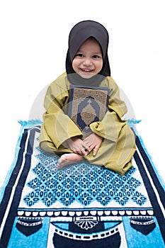 A Muslim Girl holding Quran