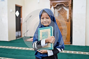 Muslim girl kid holding quran