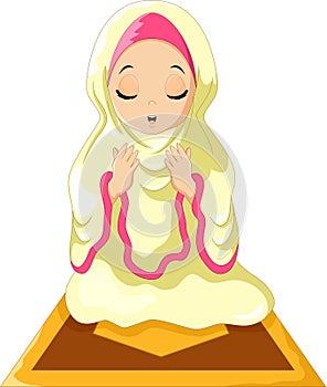 Muslim girl sitting on the prayer rug while praying