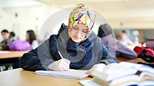 Muslim girl studying in library