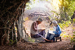 Muslim grandfather is teaching nephew to read a book. Muslims reading from the quran photo