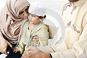 Muslim grandparents with their grandchild