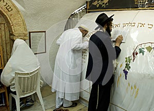 A Muslim and Jewish prayers are praying together in the tomb of the Prophet Samuel.