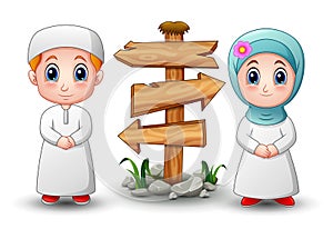Muslim kid cartoon with blank wood arrow sign