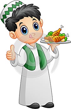 Muslim kid holding a platter of chicken meat and giving thumb up