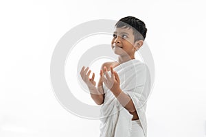 Muslim kid praying and wearing ihram