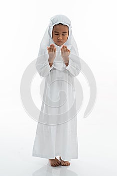 Muslim kid praying and wearing ihram