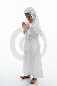 Muslim kid praying and wearing ihram