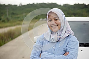 Muslim Lady Driving Her Car and Smiling