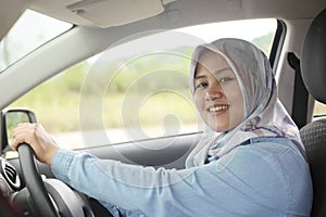 Muslim Lady Driving Her Car and Smiling photo