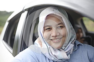 Muslim Lady Driving Her Car and Smiling photo