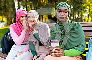 Muslim Lady Listening To Women Rumoring Whispering Behind Back Outdoors