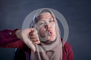 Muslim Lady Shows Thumbs Down Gesture, Disappointed Expression