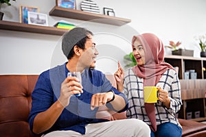 Muslim Malay couple in their home waiting for adzan maghrib