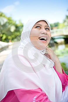 Muslim Malay woman smiling in an outdoor park