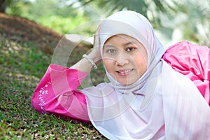 Muslim Malay woman smiling in an outdoor park