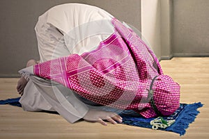 Muslim male posing prostration at home photo