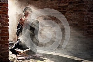 Muslim male praying in old mosque