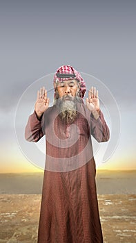 A Muslim man with agal in a praying position (salat photo