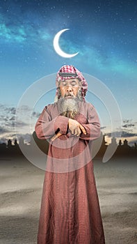 A Muslim man with agal in a praying position (salat photo