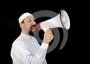 Muslim man with beard shouting through megaphone calling for Hajj