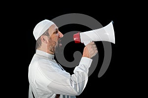 Muslim man with beard shouting through megaphone calling for Hajj