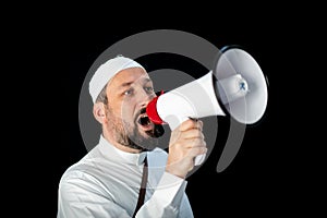 Muslim man with beard shouting through megaphone calling for Hajj