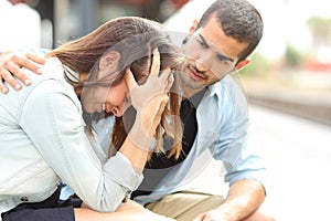 Muslim man comforting a sad girl mourning