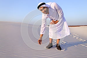 Muslim man develops sand along wind and standing in middle of de