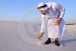 Muslim man develops sand along wind and standing in middle of de