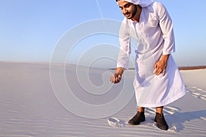 Muslim man develops sand along wind and standing in middle of de