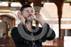 Muslim Man In Dishdasha Praying At Mosque