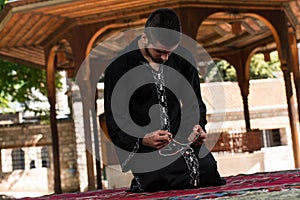 Muslim Man In Dishdasha Is Praying In The Mosque