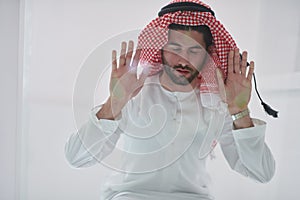 Muslim man doing sujud or sajdah on the glass floor