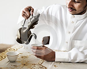 Muslim man having a cup of tea