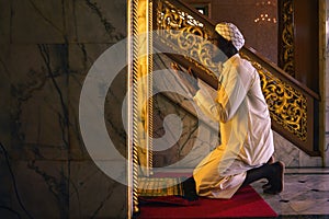 Muslim man having worship and praying in islam ceremony in mosque