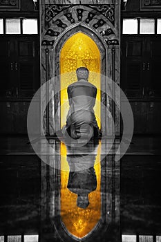 Muslim man having worship and praying in islam ceremony in mosque photo