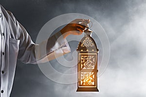 Muslim man hold arabic lantern, Ramadan kareem background