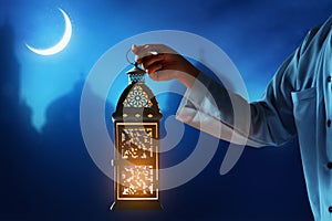 Muslim man holding arabic lantern, Ramadan kareem backgrounds