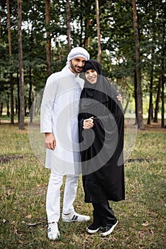 Muslim man in kufiya hugging smiling